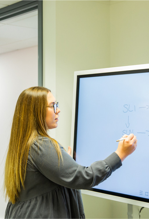 Staff member using whiteboard